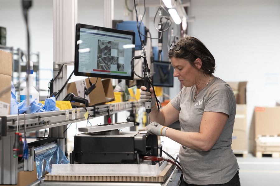 Wide view of the Novy assembly line with Azumuta screens visible