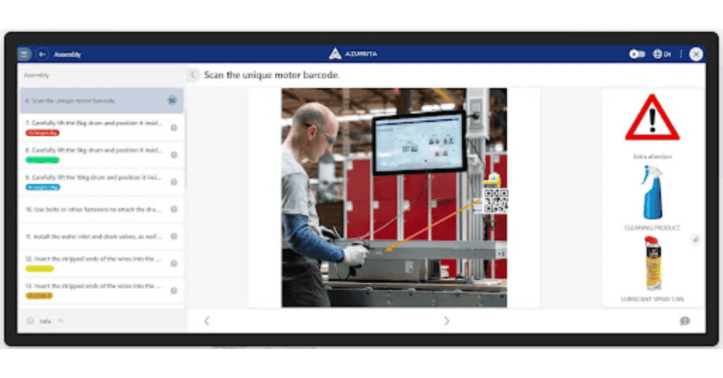 A person operates machinery, scanning a barcode on a motor in a factory setting. The image is part of an instructional software interface, featuring steps on the left. The screen on the right shows safety icons, including warnings and items like a cleaning product and lubricant spray can.