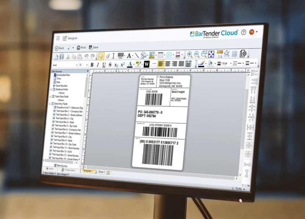 A computer monitor displays the BarTender Cloud software interface, showing barcode labels being designed. The screen features various tools and options in the toolbar and a blank label canvas with two sample barcodes, each with different numeric codes.