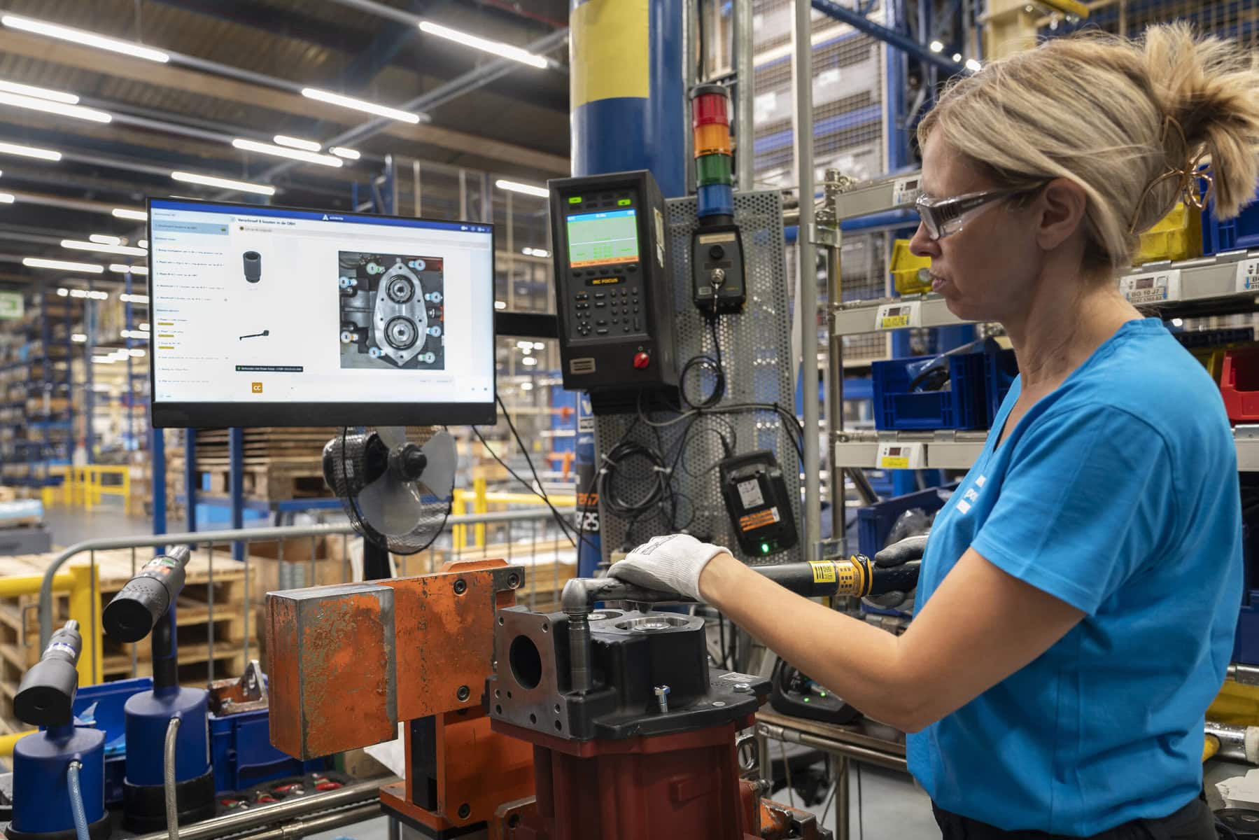 Operator using Azumuta's digital work instructions to create a part of an air compressor