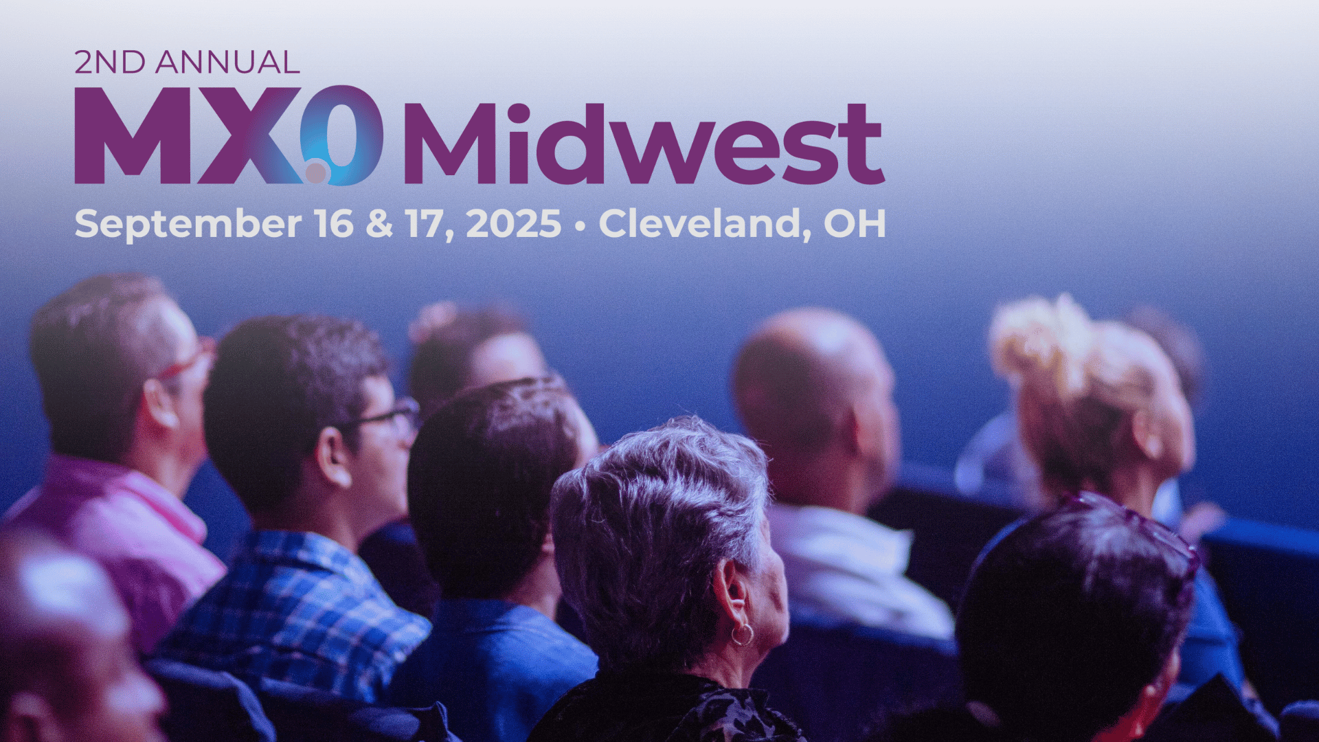 Audience members seated and facing forward at a conference, with text overlaid at the top reading 