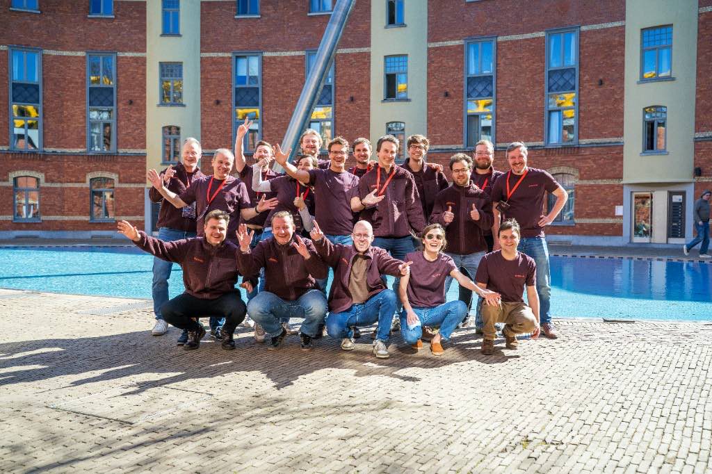 The Azumuta team posing together outdoors at a company Re-Connect event